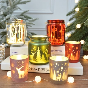 Festive Christmas glass candle holders with reindeer forest patterns in various colors