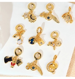 Detail of gold charms with zircon suitcase and passport airplane for DIY jewelry