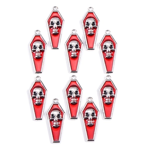 Detail of ten gothic vampire skull coffin charms with red enamel on silver alloy