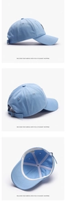Detail view of adjustable metal buckle and breathable lining on light blue cotton baseball cap