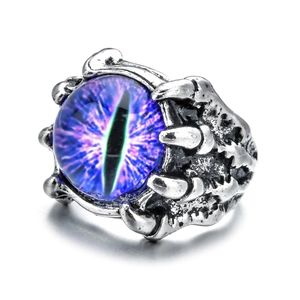 Detailed view of punk dragon claw ring with blue evil eye stone and silver scales