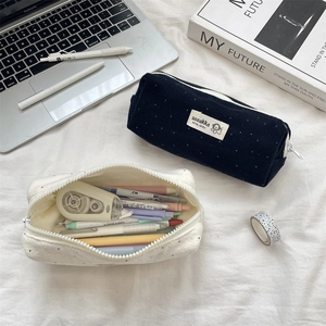 Close-up of wool dot pencil pouches showing high capacity and textured fabric detail