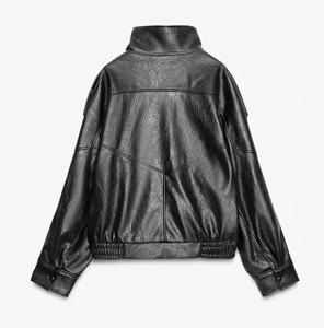 Detailed back view of a black faux leather biker jacket showing textured lychee grain leather