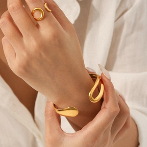 Elegant gold-plated teardrop open bangle and ring set with minimalist aesthetic