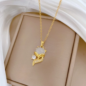 Elegant gold titanium necklace featuring a white cat-eye stone and sparkling crystals