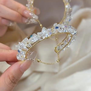 Dettaglio del bracciale geometrico in cristallo con cornice dorata e tocchi blu