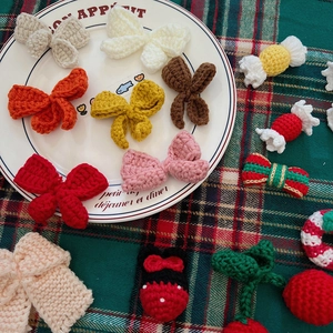 Close-up of handmade crochet Christmas bows and knit accessories for DIY festive decor