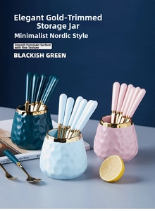 Detail of luxury ceramic storage jar with gold rim and stainless steel fruit forks