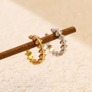Macro detail of gold and silver S925 sterling silver ear cuffs with sparkling zircons
