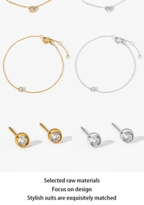 Detail of minimalist stainless steel jewelry set with round zircon in gold and silver
