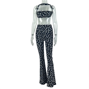 Detail of two-piece set featuring backless halter crop top and flared polka dot pants