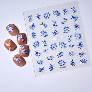 Macro view of 3D blue floral nail decals and embossed flower patterns on finished nails