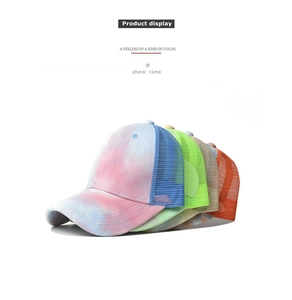 Close-up of assorted tie-dye breathable mesh baseball caps stacked in multiple colors