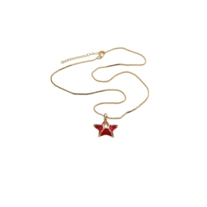 Detailed shot of a gold chain necklace featuring a red enamel star pendant with a center crystal