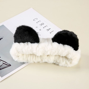 Cute panda ear plush headband in black and white on a stylish magazine background