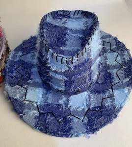 Detail of distressed patchwork denim cowboy hat with raw edges and wave stitching