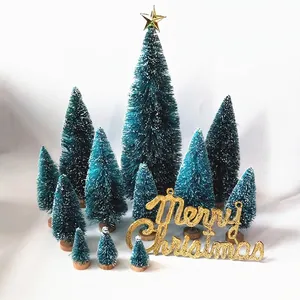 Miniature blue-green frosted Christmas trees set with gold Merry Christmas sign and wood bases