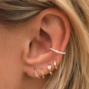 Close-up of gold-plated S925 sterling silver hoop earrings set with sparkling crystals