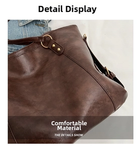 Detail view of large brown tote bag showing textured faux leather and fine stitching details