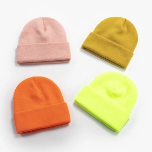 Classic knitted beanies in pink yellow orange and green colors for winter season