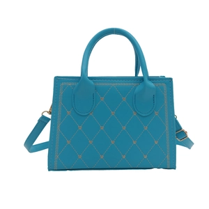 Sky blue quilted crossbody bag with small silver heart studs and top handle strap