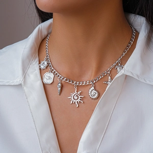 Silver chunky necklace with sea shell star and turtle pendants worn on model