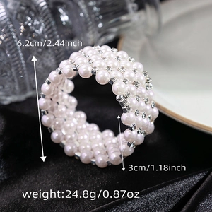 Close-up of multilayer pearl and rhinestone wrap bracelet on black velvet background