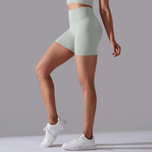 Close-up of light green seamless high-waisted yoga shorts with ribbed texture and tummy control