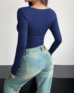 Rear view of tight-fitting navy blue long sleeve Y2K top showing the sleek fit and fabric