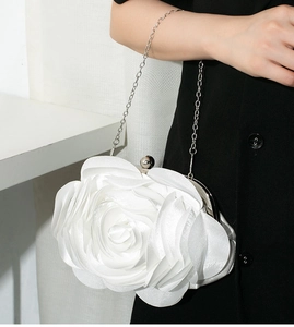 Close-up of white 3D rose flower evening bag in silk satin with silver chain