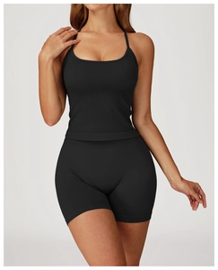 Close-up of seamless black ribbed knit yoga set with cross straps and high waist shorts