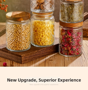 Detailed view of embossed glass storage jars with wooden lids for kitchen organization