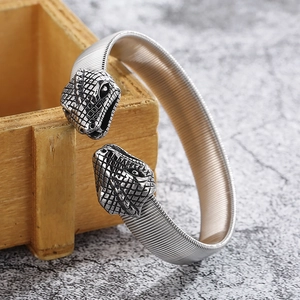 Detail of silver snake head punk bracelet with elastic flexible woven steel band