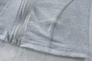 Detail shot of the durable plastic zipper and soft knit fabric texture of the gray set