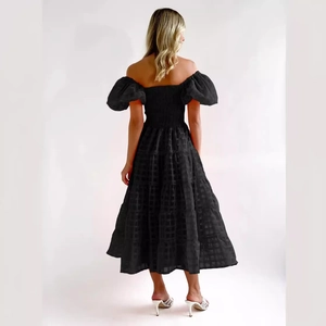 Black off-shoulder puff sleeve tiered dress with textured check fabric, back view on model