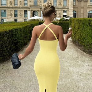 Detailed back view of a yellow knitted bodycon dress with criss-cross back strap design