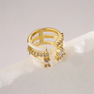 Detailed macro of gold plated ring with white enamel and sparkling zircon stones on a rock