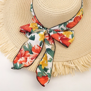 Wide brim straw sun hat with colorful floral ribbon and stylish frayed tassel edges