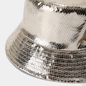 Detail of metallic gold bucket hat featuring laser PU snakeskin texture and stitching