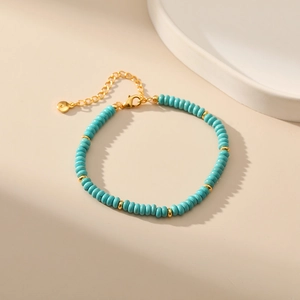 Detail of bohemian turquoise beaded bracelet with gold extension chain and lobster clasp
