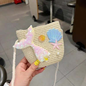 Detail of beige straw bag for girls with sequined mermaid tail and shell pearl decor