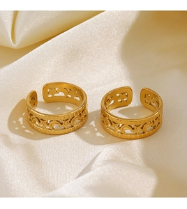 Detailed view of two 18K gold plated V-shaped hollow star and moon rings on satin fabric