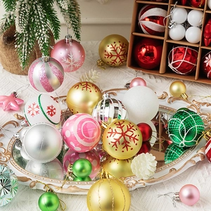 Assorted Christmas balls with glitter and snowflake prints in a decorative tray