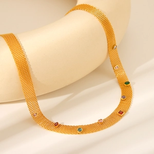 Close-up of gold mesh chain necklace featuring colorful multi-shape gemstones on white pedestal