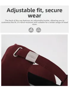Macro detail of the adjustable matte silver metal buckle on a burgundy baseball cap