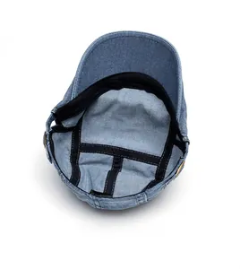 Internal view of blue denim newsboy cap showing reinforced stitching and sweatband details