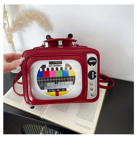 Macro detail of retro TV bag showing side heart rivets and silver tuning knobs