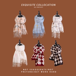 Detail of winter scarf collection with tassels and classic plaid patterns in various colors