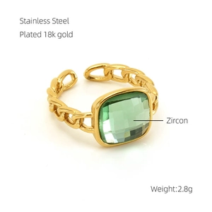 Detailed view of 18k gold plated stainless steel ring with green zircon and chain texture