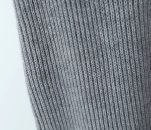Close-up of gray ribbed knit fabric texture on high-waist loose knit trousers